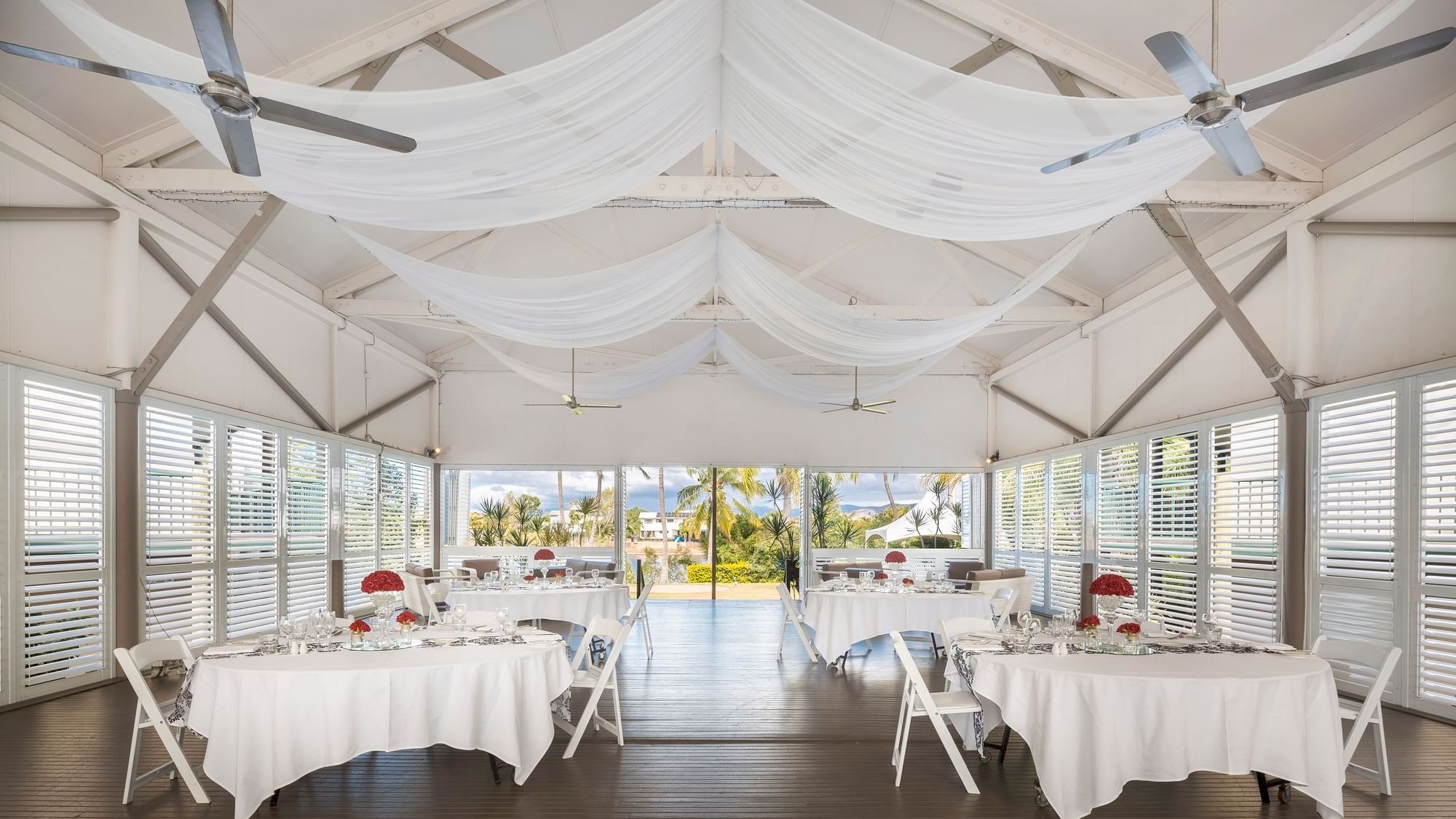 Elegant dining setup in Plantation Deck windows showcasing tropical views at Mercure Hotel Townsville