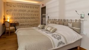 Interior of a room with a king bed at The Originals Hotels