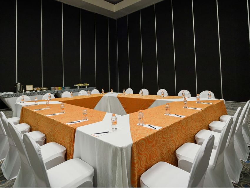Large event room setup with tables and chairs at Real Inn Tijuana in Tijuana