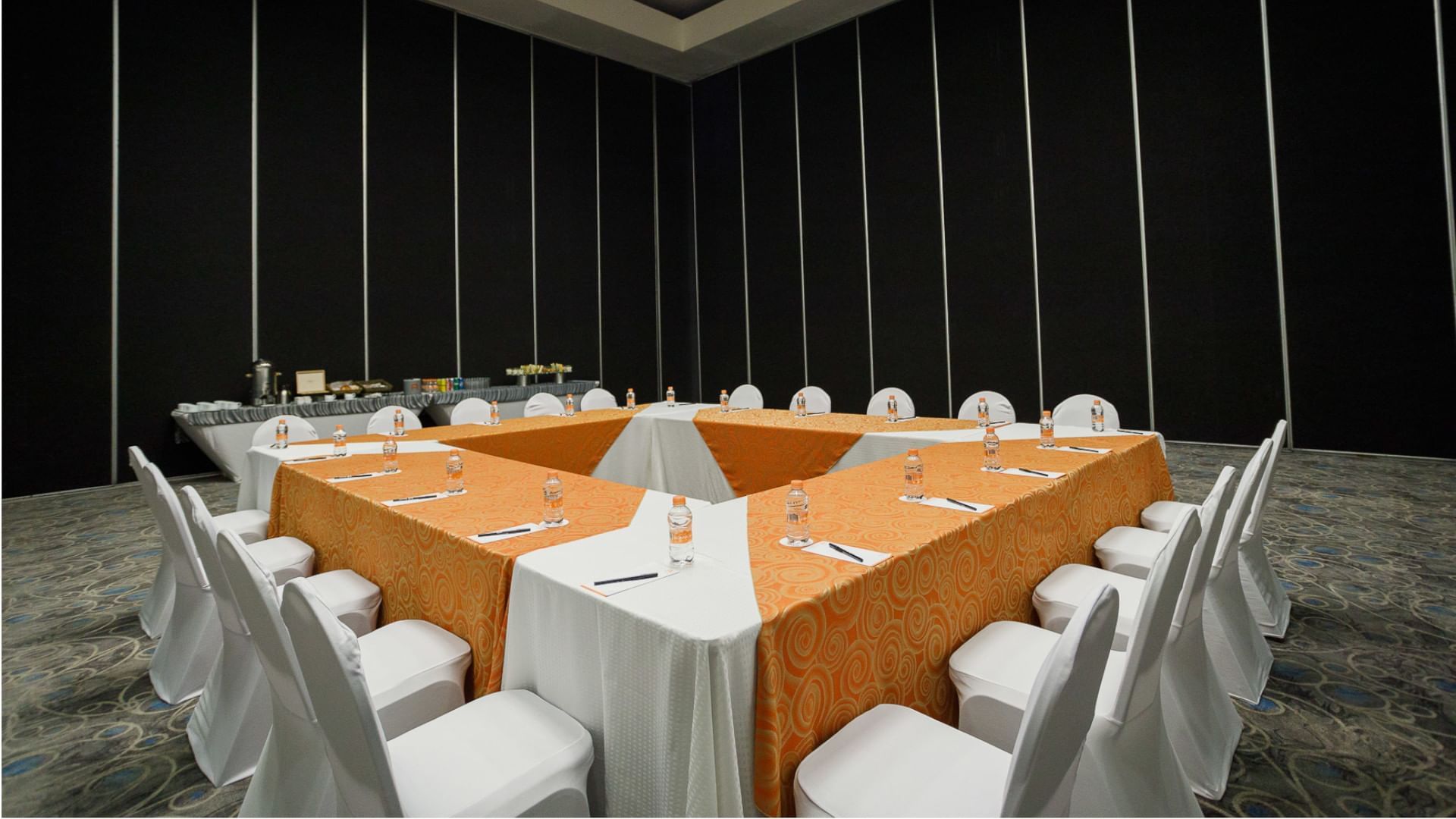 Large event room setup with tables and chairs at Real Inn Tijuana in Tijuana