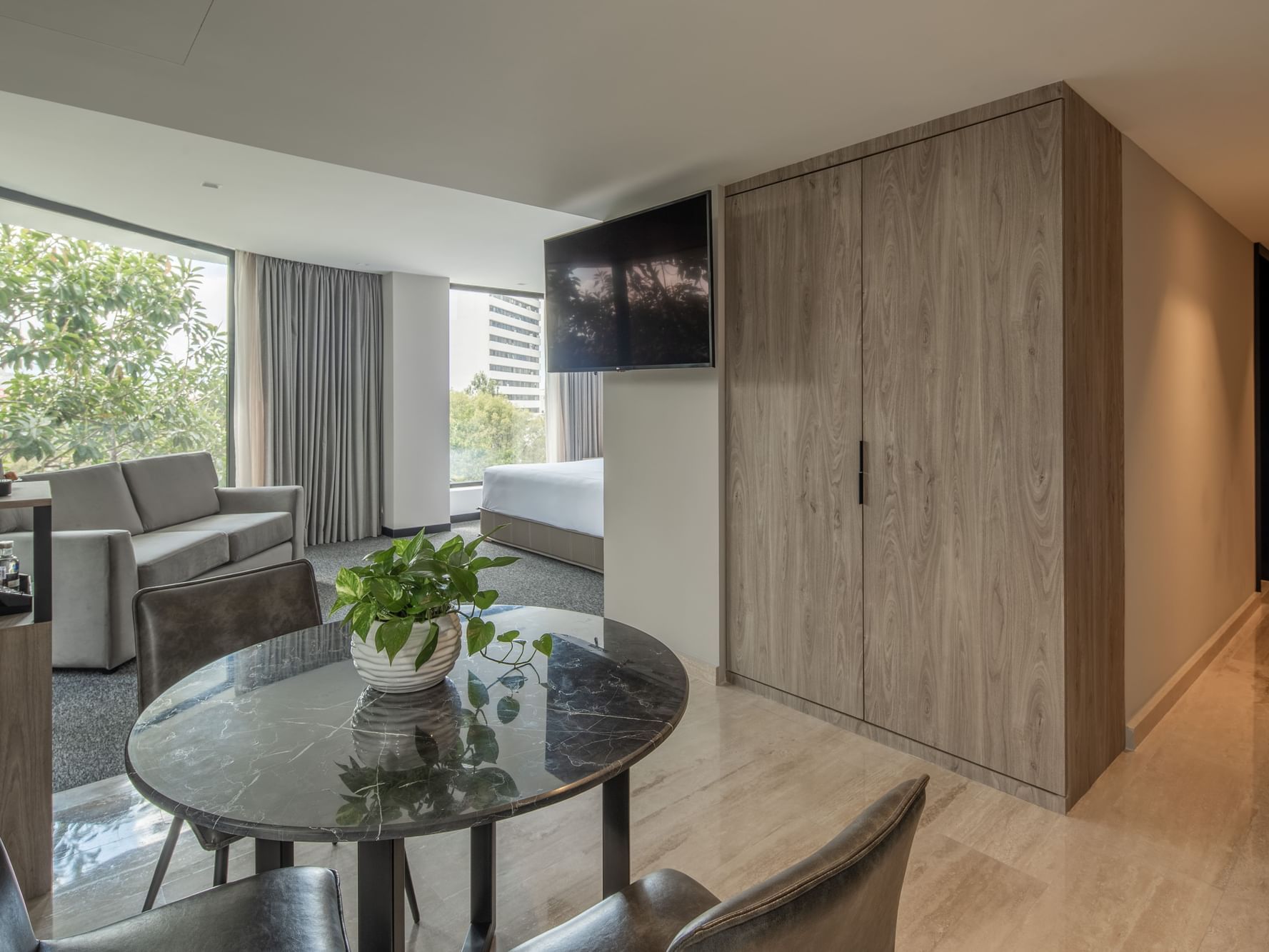 Elements Suite with modern furnishings and large windows at Elements by Marquis in Ciudad de México.
