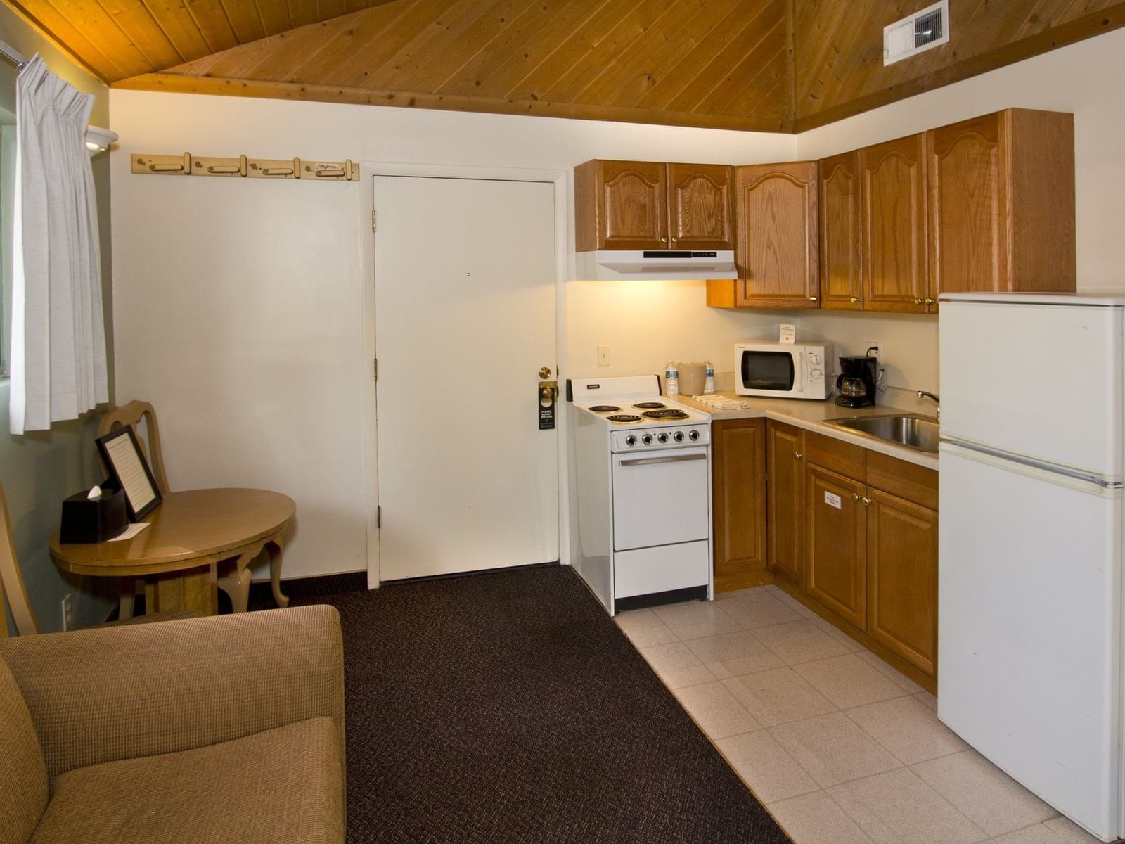 Open kitchen with table, sofa in Studio Cabin at Alpenhof Lodge