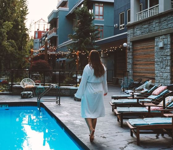 A lady walk by the pool at Paradox Hotels