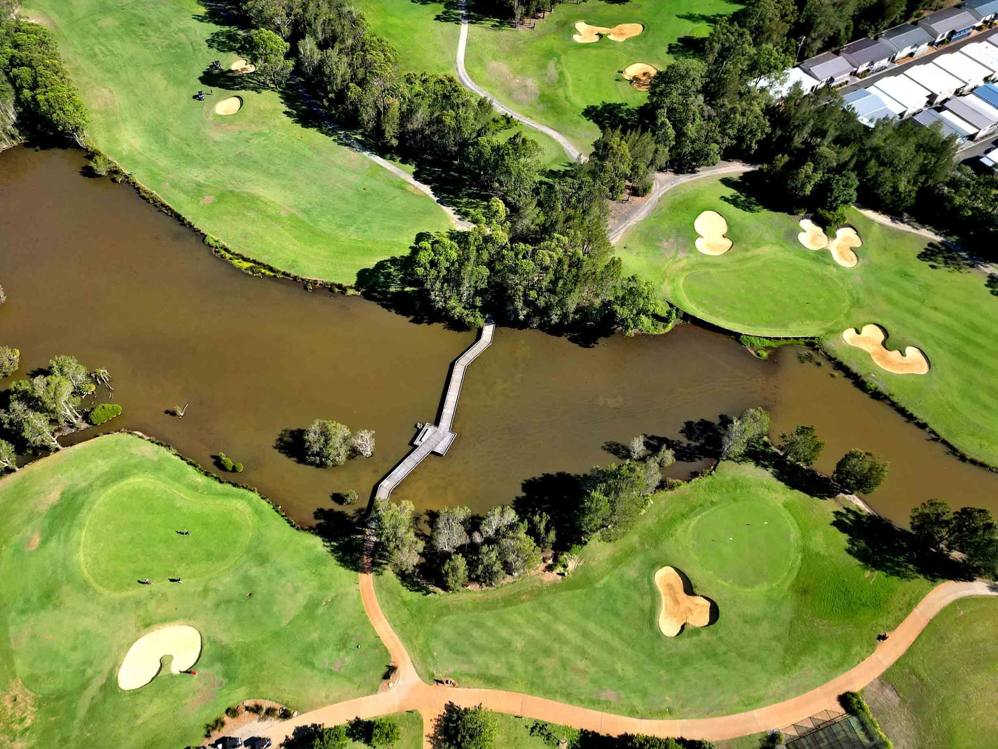 Aerial view of Kooindah Waters Golf Course with a lake by Mercure Kooindah Waters
