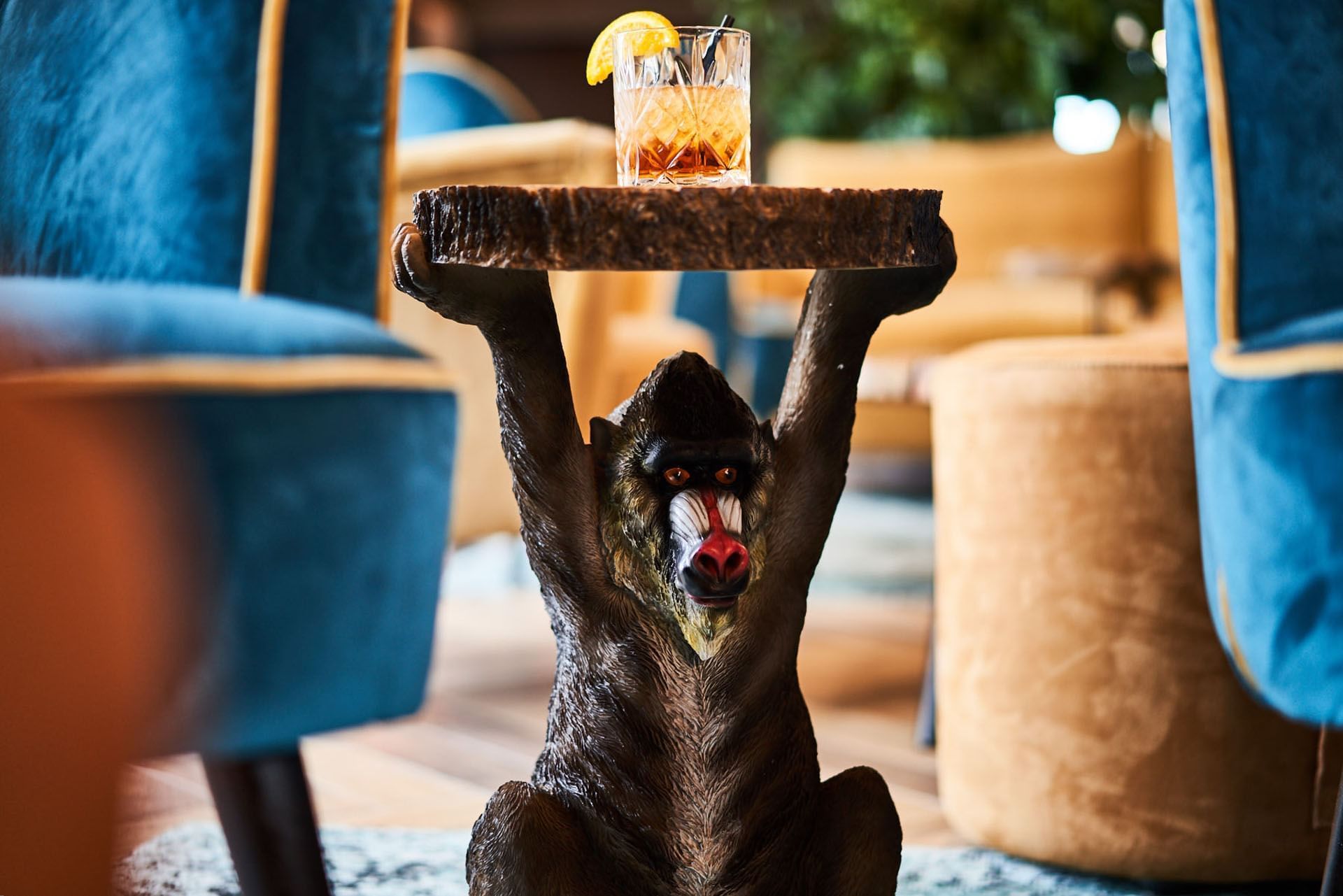 Cocktail served on a monkey stool in the bar at Kopster Hotel Lyon Groupama Stadium