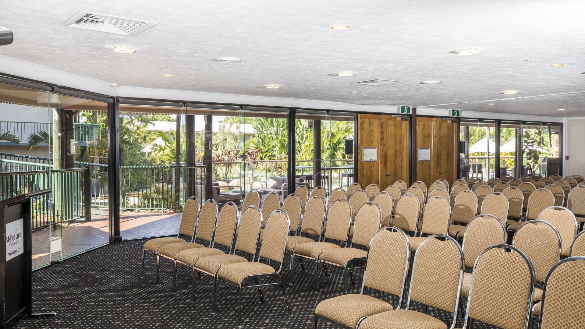 Lakes Room featuring theater set up with large windows overlooking the garden at Mercure Hotel Townsville