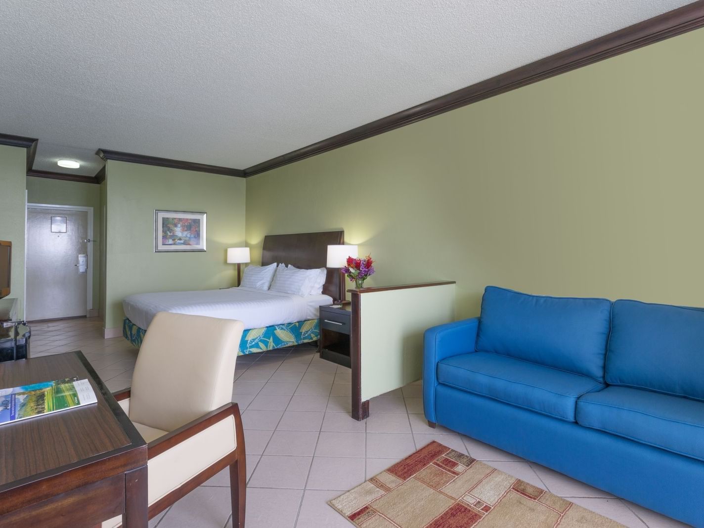 Work desk & comfy sofa by the king bed in Junior Suite at Holiday Inn Montego Bay