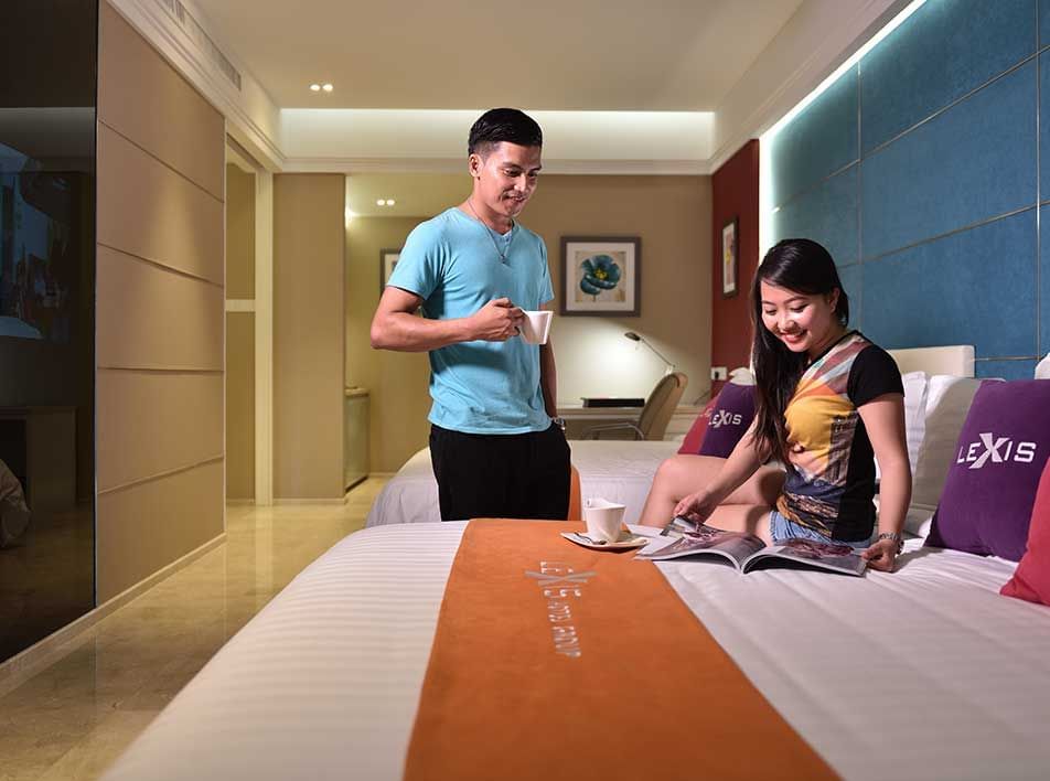 couple spending time in a spacious luxury hotel room at Lexis Suites Penang