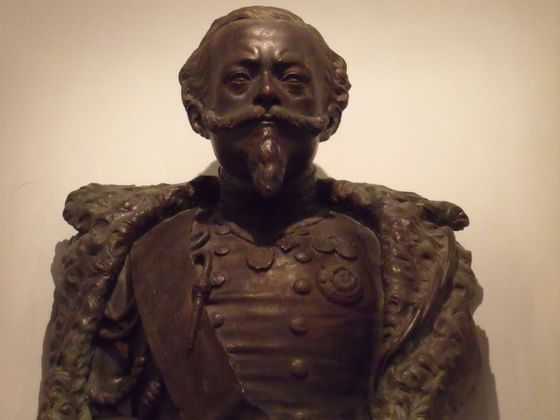 Close-up of a bronze bust of a man in a room at Bettoja Hotels Group