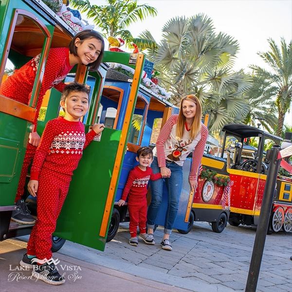 Kids posing in Santa Workshop Experience at ICON Park® near Lake Buena Vista Resort Village & Spa