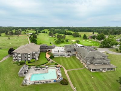 Aerial view of Rodd Brudenell River Resort by a pool under blue Sky, Premier places to stay in PEI