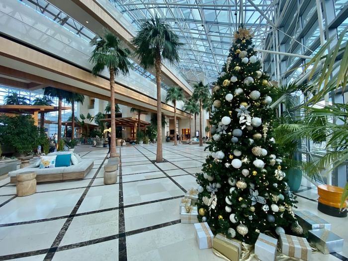 Christmas tree stands in the center of decorated lobby at The Diplomat Resort