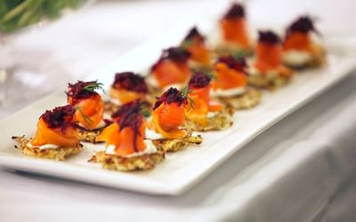 Close-up of smoked salmon canapés on a white plate served at Spencer Hotel & Conference Centre