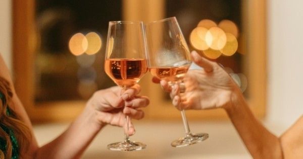 People toasting wine glasses at a celebration