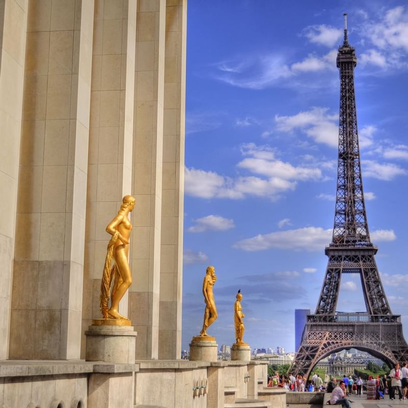 Golden statues stand at Trocadéro with the Eiffel Tower, showcasing Paris's iconic scenery near Warwick Hotels and Resorts