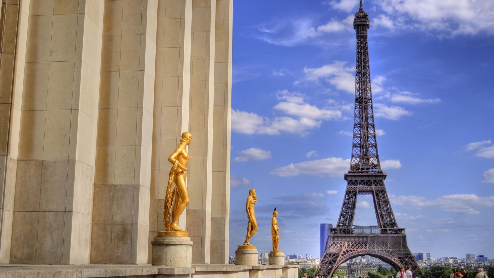 Golden statues stand at Trocadéro with the Eiffel Tower, showcasing Paris's iconic scenery near Warwick Hotels and Resorts