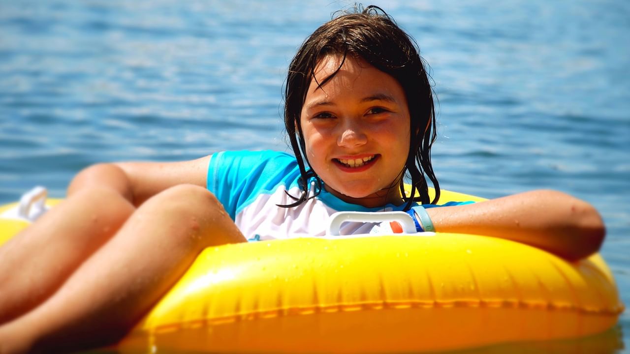 girl on a yellow inflatable water tube