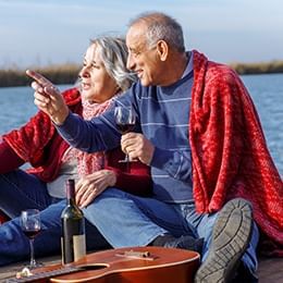 Boomers drinking wine by the water