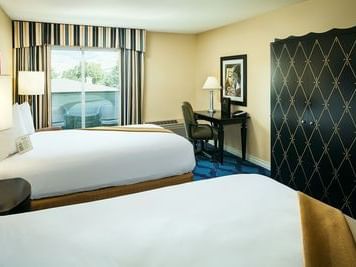 Double bed with work area in Deluxe Double Queen of Plaza Inn & Suites at Ashland Creek​
