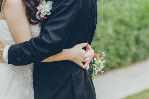 Bride & groom hugging at Carlton Hotel Singapore