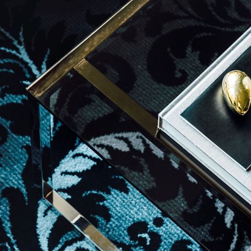 Items on a glass table in Gold Penthouse at Como Melbourne