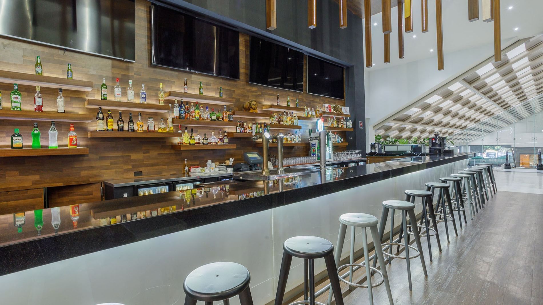 Stock Bar featuring well-stocked liquor shelves and beer taps at Real Inn Tijuana