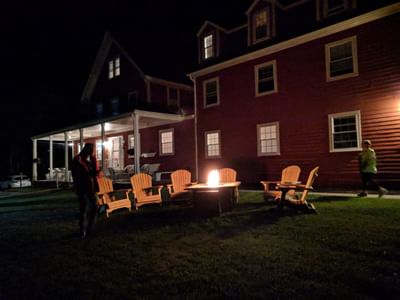 Surfside Inn Exterior At Night With Fire Pit and Seating