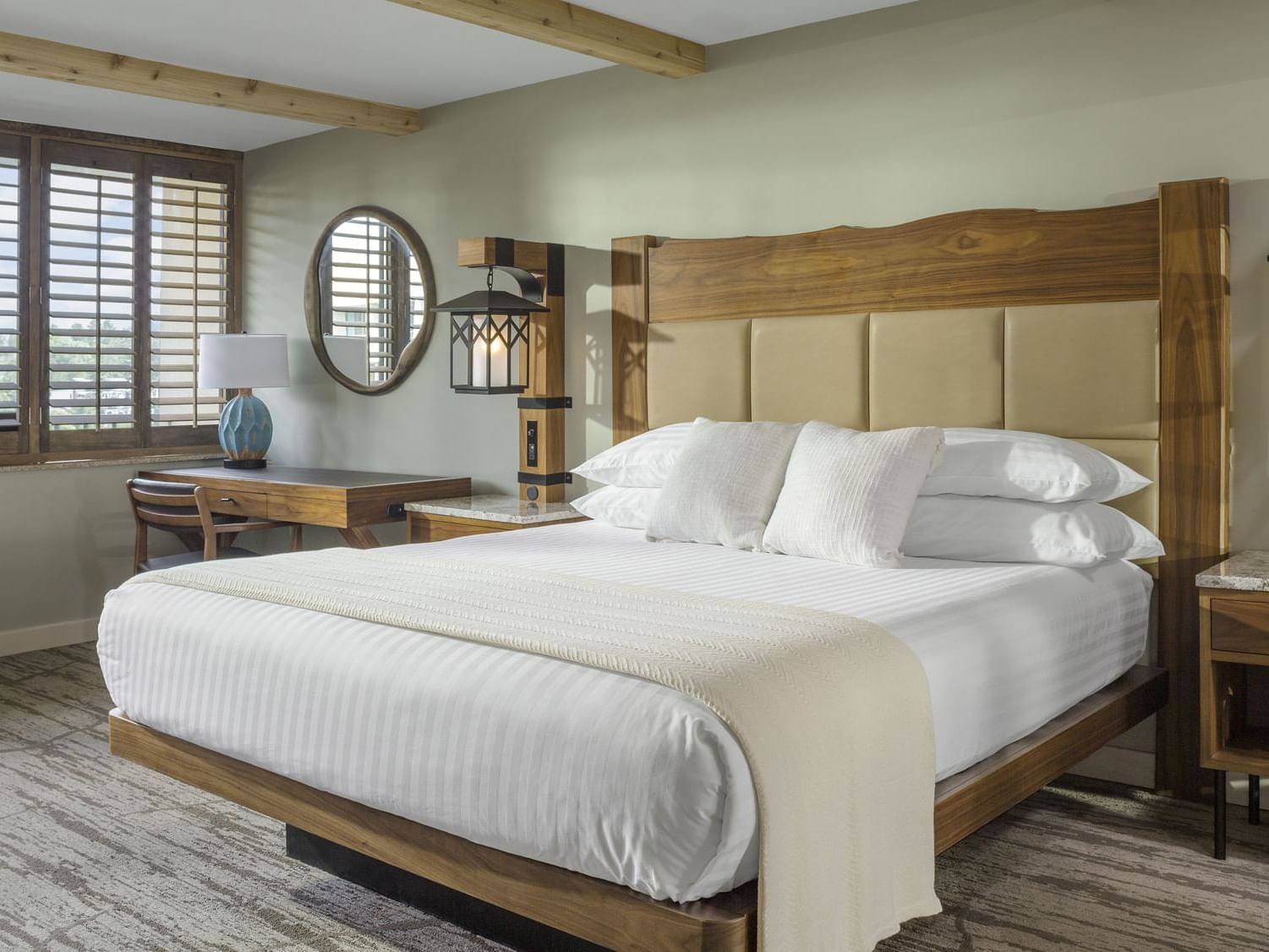 Resort Suite Bedroom with a king bed, lamp & desk at High Peaks Resort