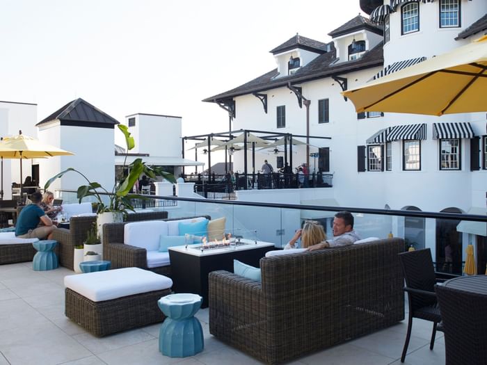 People enjoying the exterior lounge area at The Pearl Hotel