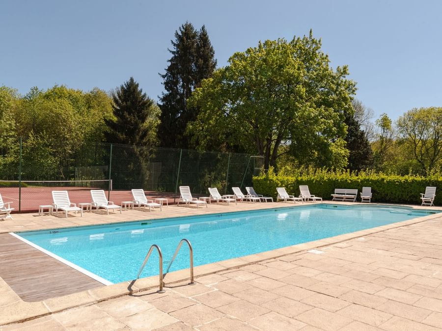 Sunbeds by the outdoor pool at Chateau du Landel