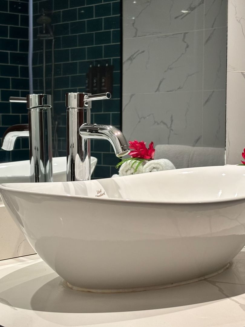 Clean bathroom sink and towels with garden view at Warwick Fiji Resort and Spa in Korolevu.