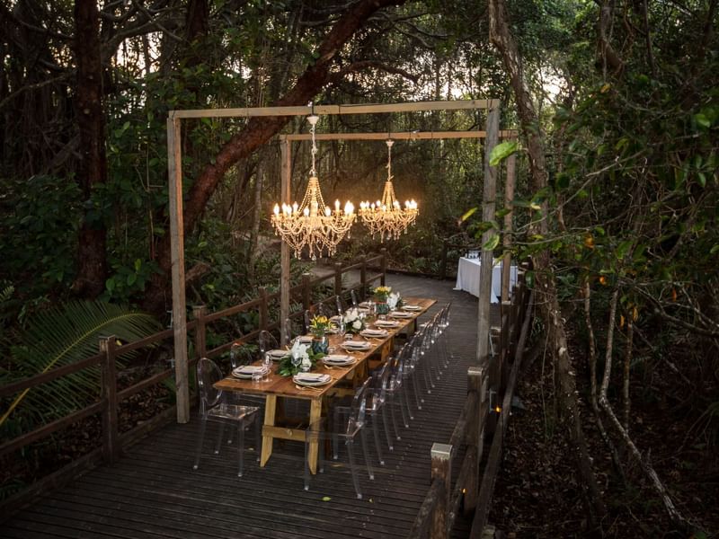Dining setup with chandelier over long table in Boardwalk at Pullman Port Douglas Sea Temple Resort & Spa