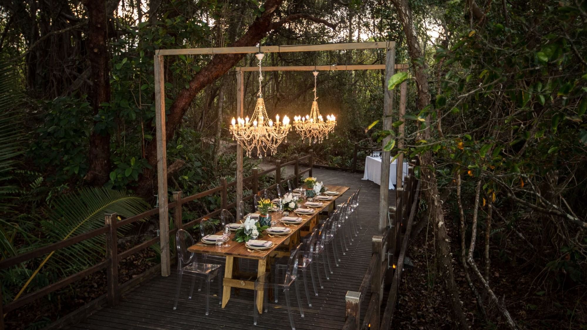 Dining setup with chandelier over long table in Boardwalk at Pullman Port Douglas Sea Temple Resort & Spa