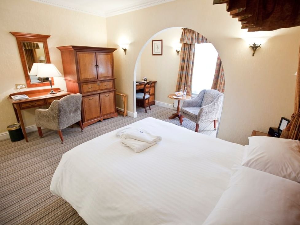 Brampton Lodge Executive Room at Marygreen Manor, with classic décor, a work area, and an archway to a cozy seating area