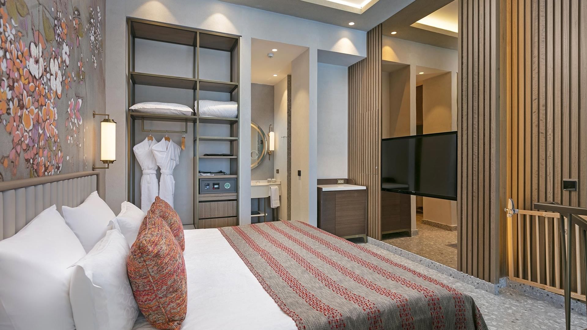 Closet by the bed in Family Duplex Room with floral wall art at Cullinan Belek