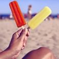 A person in the beach eating popsicles at Inn at Avila Beach