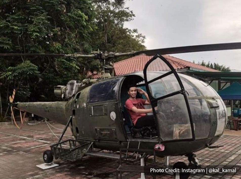 Man posing in helicopter at Army Museum - Lexis Hibiscus
