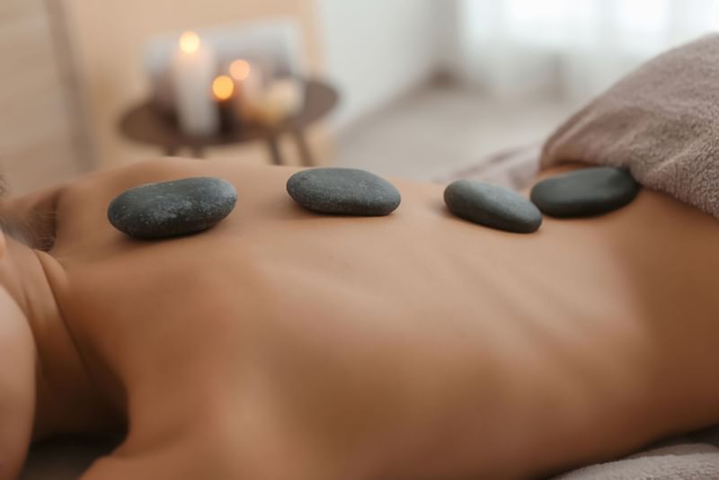Lady receiving a stone treatment at Le Spa by Warwick Melrose Dallas