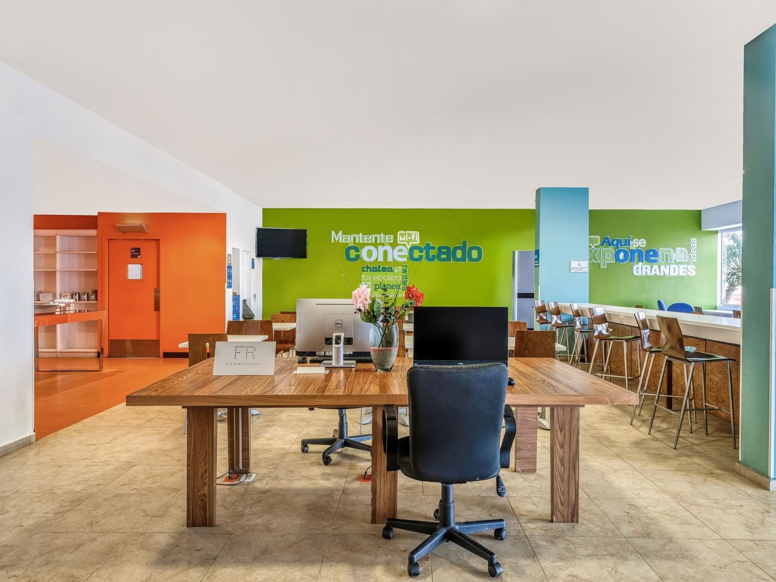 Modern office lobby with desks, chairs at One Hotels