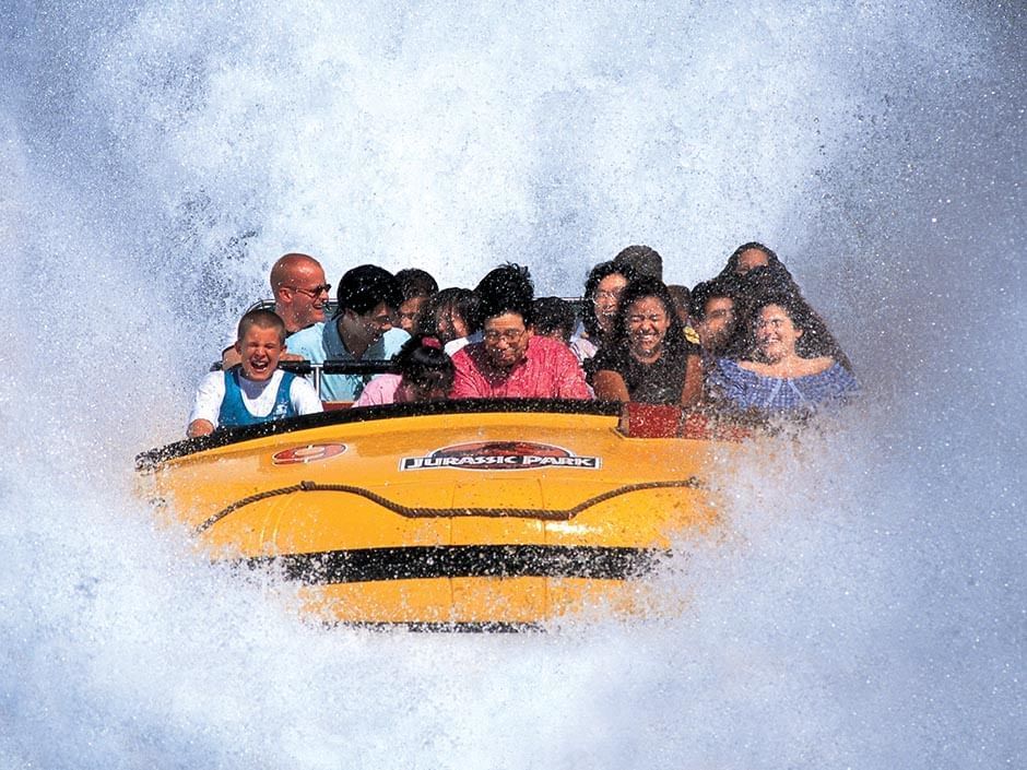 A boat splashes down a hill on Jurassic Park River Adventure, a water ride at Universal Orlando Resort.
