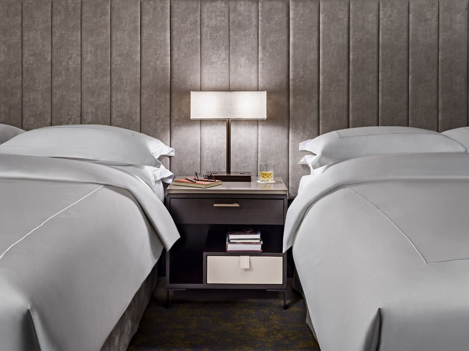 Two beds with nightstand in Signature Two Queen at Hotel X, a downtown Toronto hotel