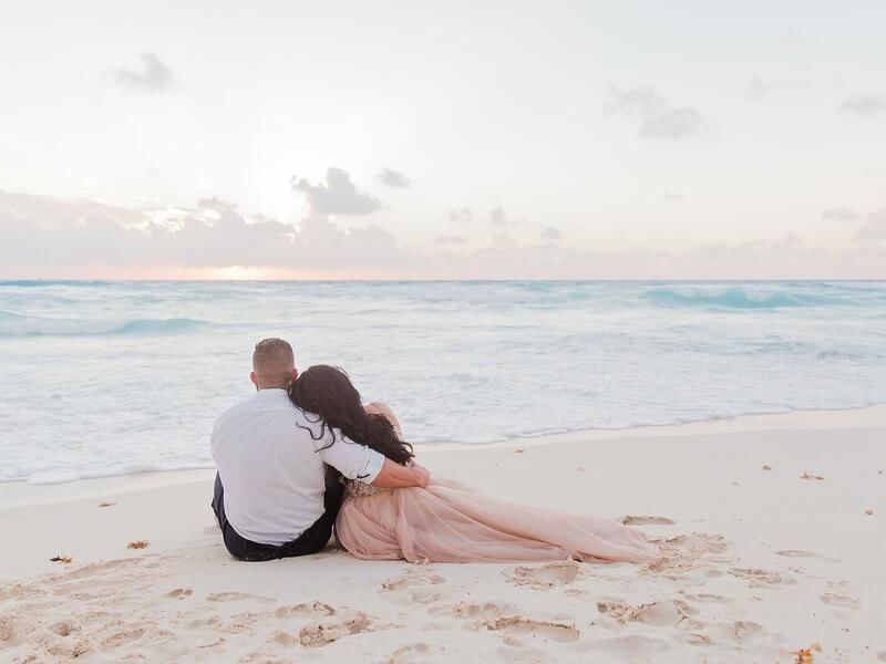A couple enjoying a sunset on the beach at FA Hotels & Resorts