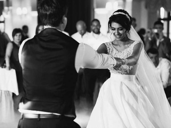 B & W portrait of a wedded couple dancing at Warwick Melrose