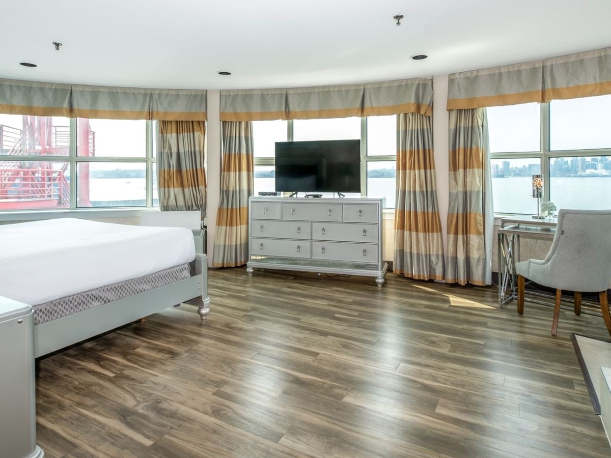 Coast Carrie Cates Penthouse Suite with large bed, wooden floors, TV, desk at Coast Lonsdale Quay Hotel