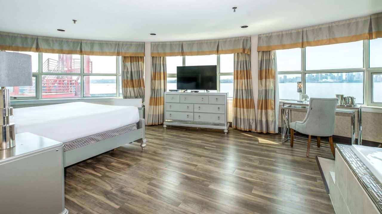 Coast Carrie Cates Penthouse Suite with large bed, wooden floors, TV, desk at Coast Lonsdale Quay Hotel