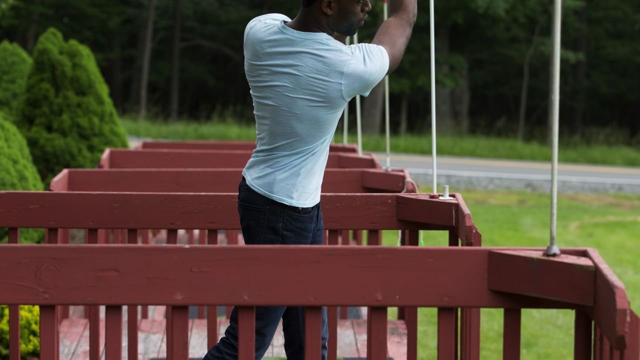 Man taking a shot at Miniature golf in Cove Pocono Resorts