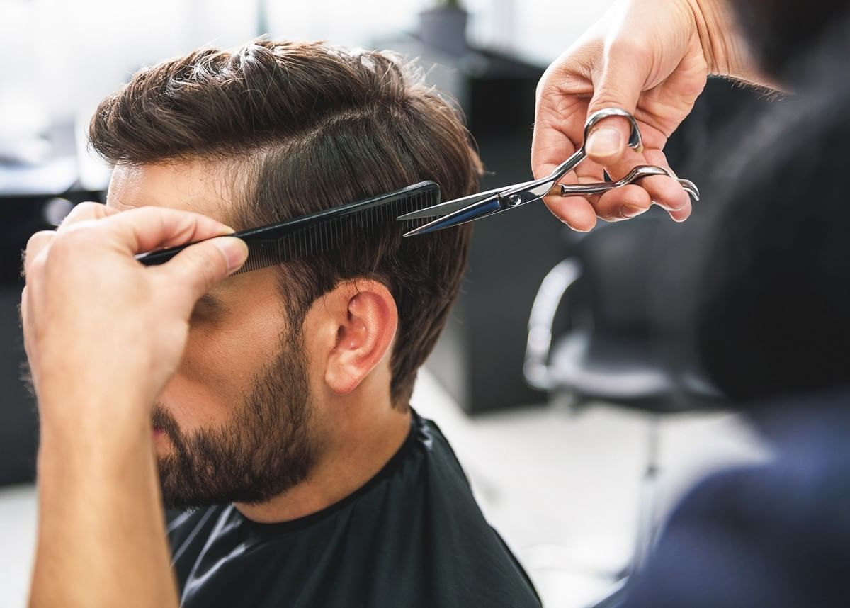 Man getting hair cut near disney world at Reflections Spa and Salon