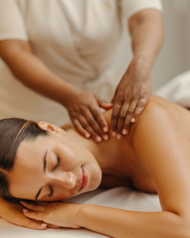 Woman receiving a relaxing back massage at Guerlain Spa