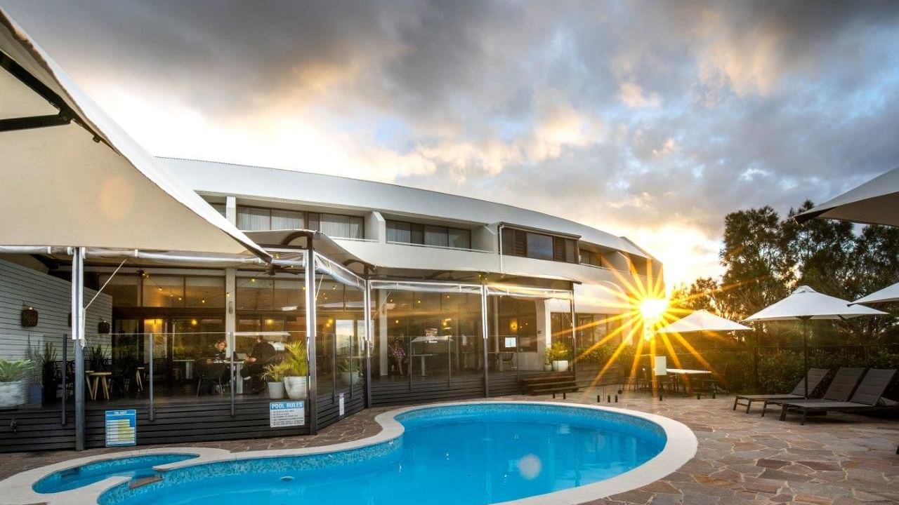 Resort pool with sun setting at Mercure Charlestown.