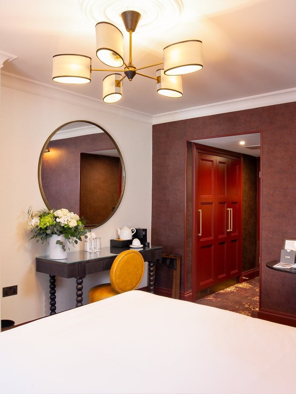 Elegant Superior Room interior with vanity table near bed at The Capital Hotel, Apartments & Townhouse
